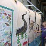 Maggie Wong tells a parent about the event and shows the materials created by teen volunteers for the library.                                (Evan Pappas/Staff Photo)