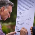 Dow Constantine writes &ldquo;Thank you!&rdquo; on the list of recommendations from the Fish, Farm, Flood advisory committee.                                Photo courtesy of Eli Brownell