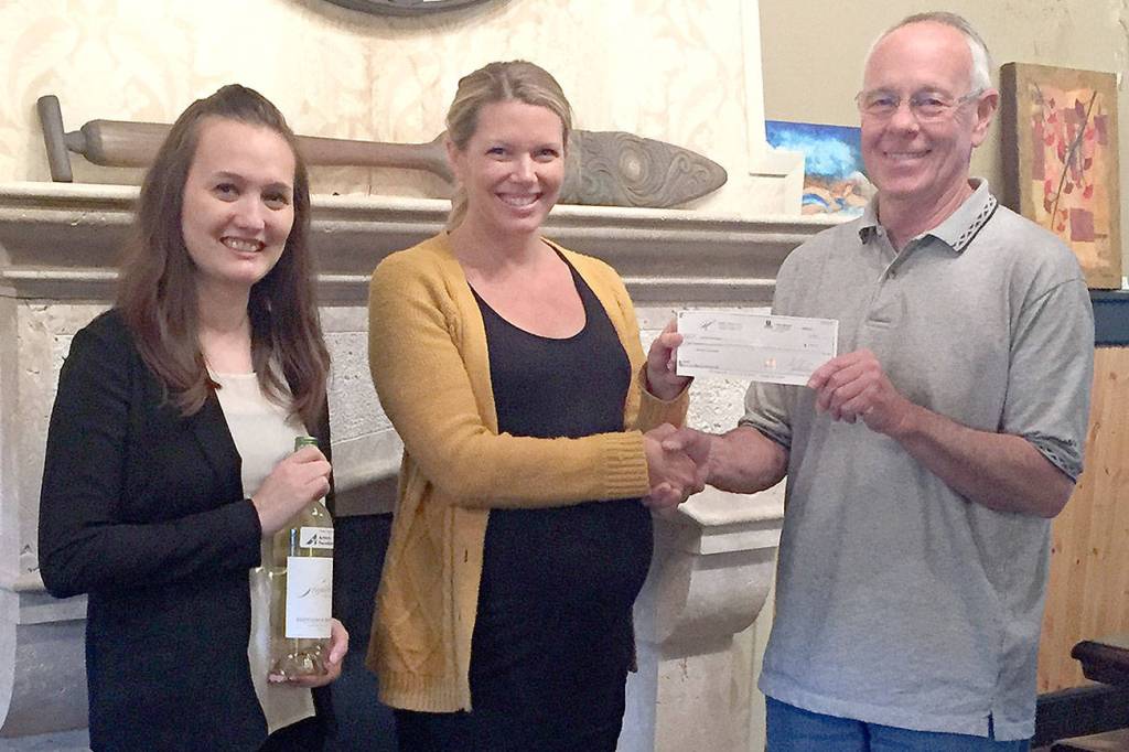 Sigillo Cellars owner and head winemaker, Mike Seal, right, presented a check representing 10 percent of Sigillo&rsquo;s sales of Sauvignon Blanc in May, to Arthritis Foundation Development Manager Toni Arrowsmith, left, and Arthritis Foundation Senior Executive Director Kelsey Woods.                                Courtesy Photo