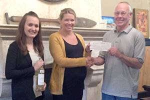 Sigillo Cellars owner and head winemaker, Mike Seal, right, presented a check representing 10 percent of Sigillo&rsquo;s sales of Sauvignon Blanc in May, to Arthritis Foundation Development Manager Toni Arrowsmith, left, and Arthritis Foundation Senior Executive Director Kelsey Woods.                                Courtesy Photo