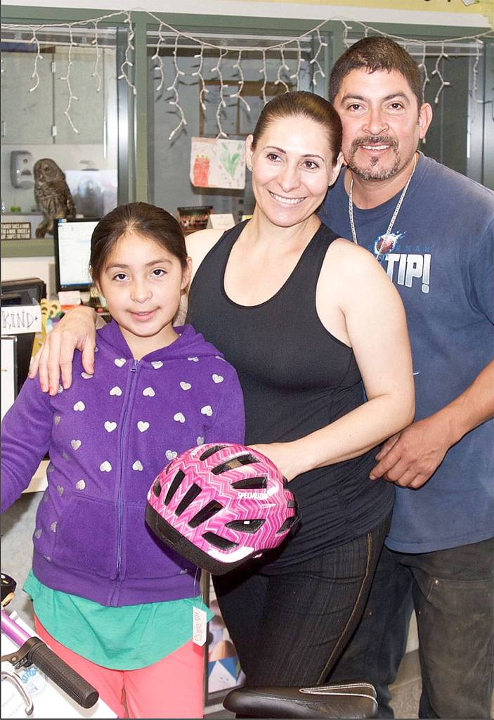 Janet Becerra Celis, pictured with her parents, Elia and Erasmo, is a 2017 Bikes for Books winner at Fall City Elementary School.                                Courtesy Photo