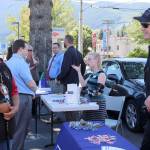 Snoqualmie Tribe Chief Andy De Los Angeles speaks with Officer Chad Ridout at the Snoqualmie Police Department booth at last week&rsquo;s community job fair.                                (Evan Pappas/Staff Photo)