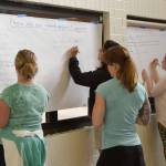 Residents write comments on provided feedback lists at the open house Wednesday on the Tolt Hill Bridge closure.                                Carol Ladwig/Staff Photo