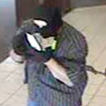 This file photo shows the man who robbed the North Bend Chase Bank branch entering the building, July 6, 2012.                                File Photo
