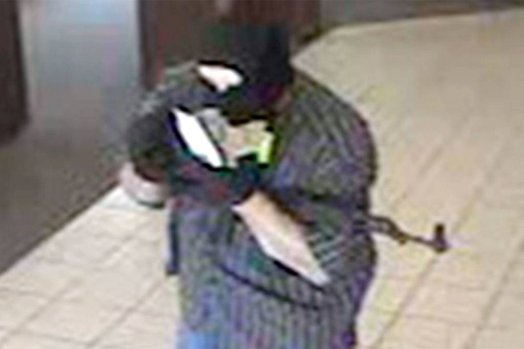 This file photo shows the man who robbed the North Bend Chase Bank branch entering the building, July 6, 2012.                                File Photo