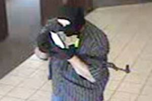 This file photo shows the man who robbed the North Bend Chase Bank branch entering the building, July 6, 2012.                                File Photo