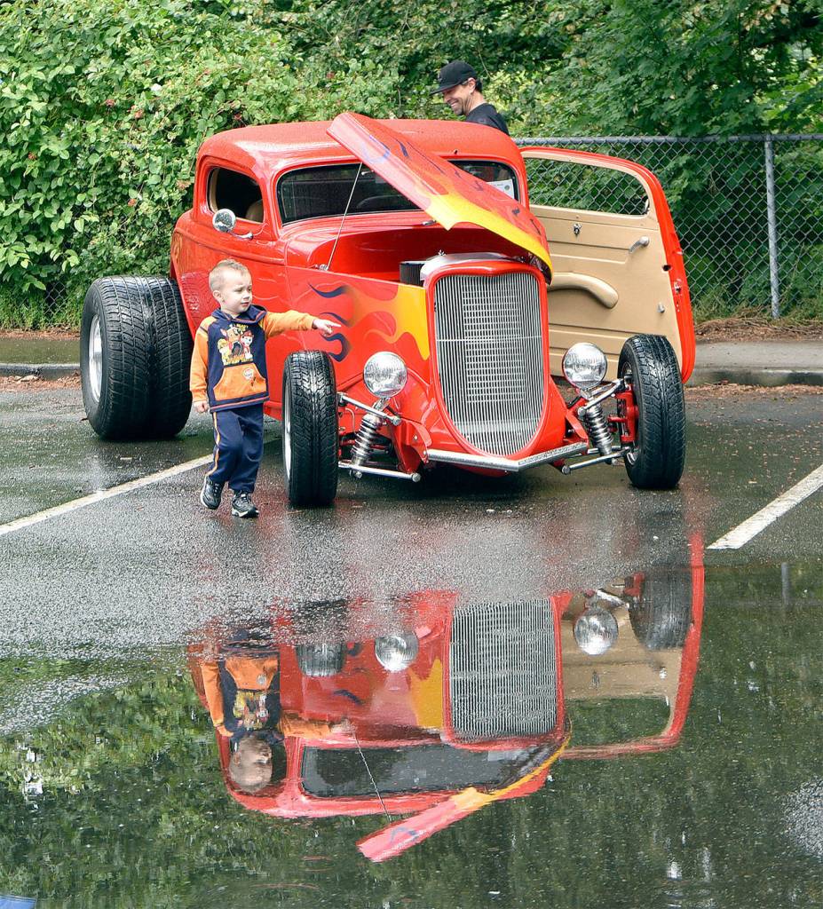 Bentley Steele, 3, points out his favorite features on Tom DeStefano&rsquo;s 1934 Highboy at the 2016 car show.                                Carol Ladwig/File Photo