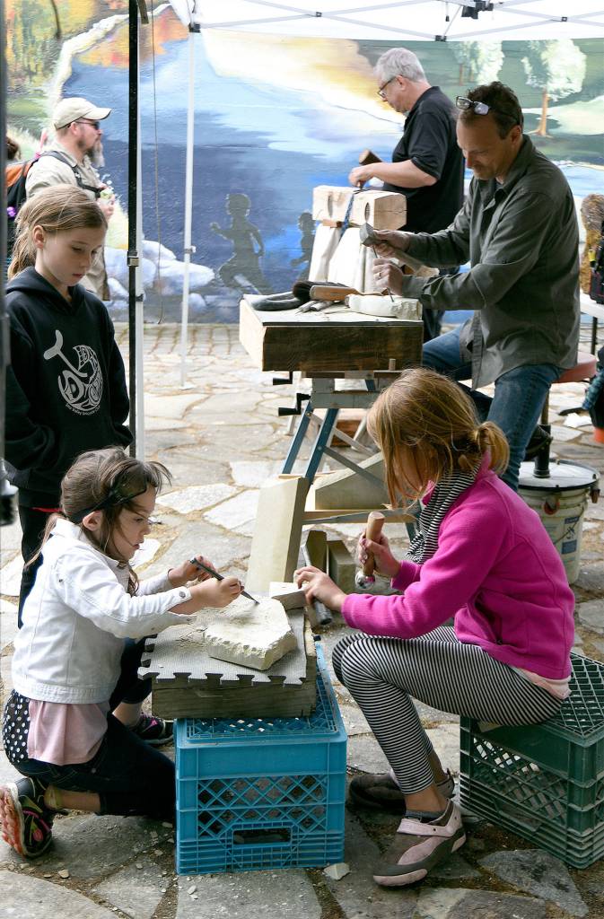 Children try their hand at sculpting during the art park demos.                                Carol Ladwig/File Photo