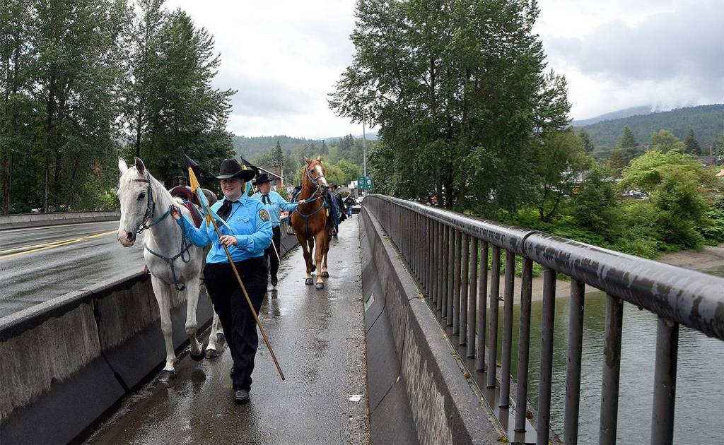 Riders walk their horses over the S.R. 202 bridge after the parade.                                Carol Ladwig/File Photo