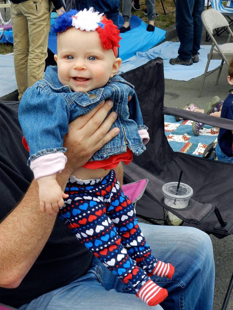 A costumed baby smiles as she watches the parade.                                File Photo