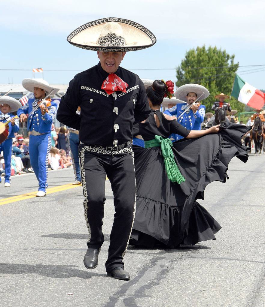 Ixtapa dancers finish out the Carnation parade with fancy footwork. (Carol Ladwig Staff Photo)
