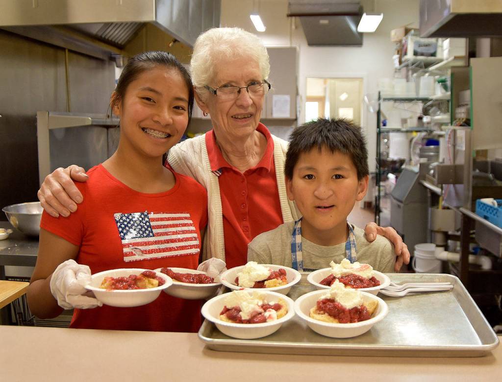 Dolores Ulrich and her grandchildren, Sarah Day, 14 and Joseph Day, 13, takes a short break from serving up strawberry shortcake at the Sno Valley Senior Center for a photo. (Carol Ladwig Staff Photo)