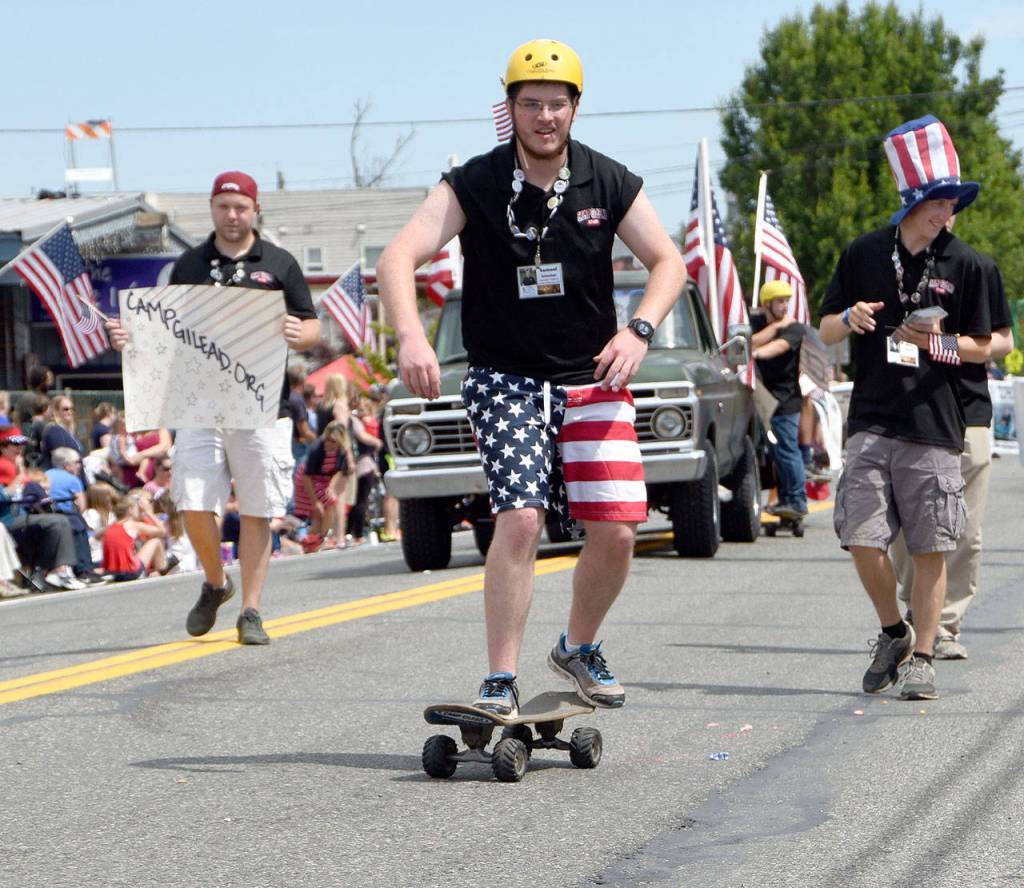 Camp Gilead volunteers march and roll ahead of their float. (Carol Ladwig Staff Photo)