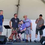 Bev Jorgensen brings representatives from Valley communities to the stage. From left, Snoqualmie Mayor Matt Larson, Deputy Mayor of Carnation Dustin Green, North Bend Mayor Ken Hearing, and President of the Fall City Parks Commission Perry Wilkins. (Evan Pappas/Staff Photo)