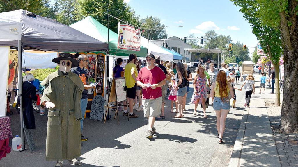 Volunteers with Night on a Dark Trail give a creepy welcome to people at the Block Party. Carol Ladwig/Staff Photo