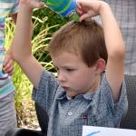 Samuel Nearn beats the heat Saturday by squeezing a water bottle over his head. Carol Ladwig/Staff Photo