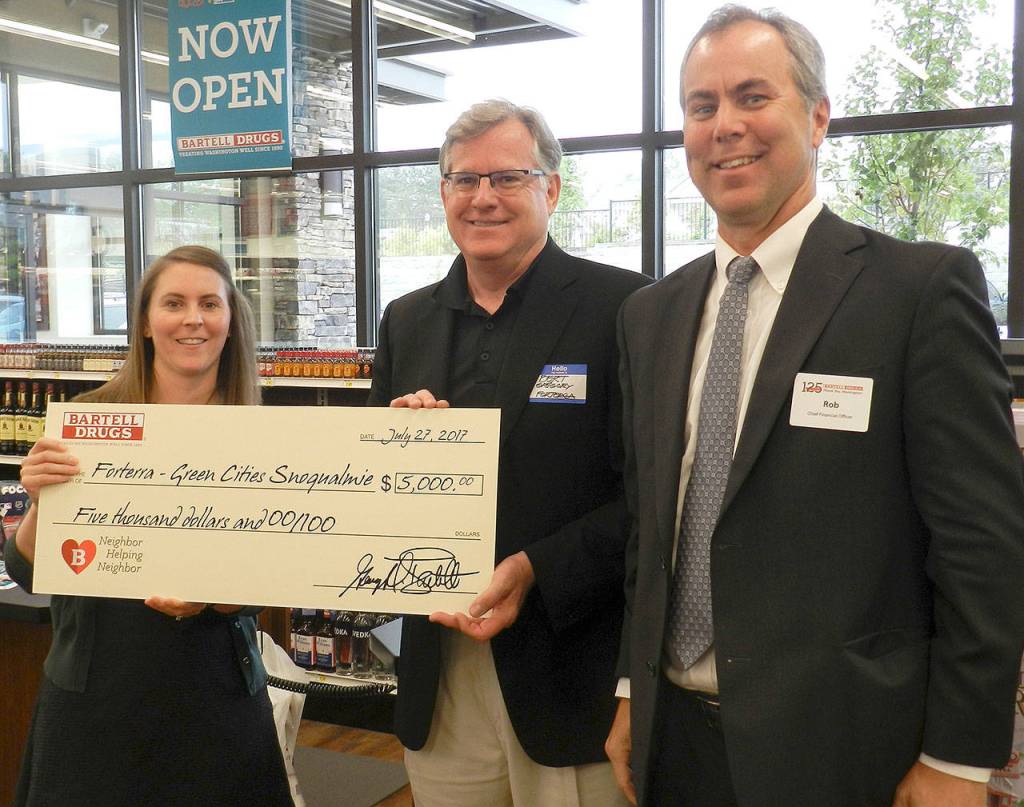 Bartell Drugs staff also announced the company would make a $5,000 donation to Forterra, in support of its Green Cities program. Pictured from left are Senior Marketing Manager ​​Evelyn ​​Barber Merrill​, board member Burt Gregory, ​​and Chief Financial Officer Rob Jensen​.                                (William Shaw/Staff Photo)