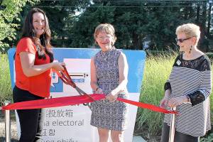 Councilmember Kathy Lambert, center, Elections Director Julie Wise, and Michele Drovdahl of the King County Library System, cut the ribbon on the new election drop box in front of the Fall City Library.                                Courtesy Photo