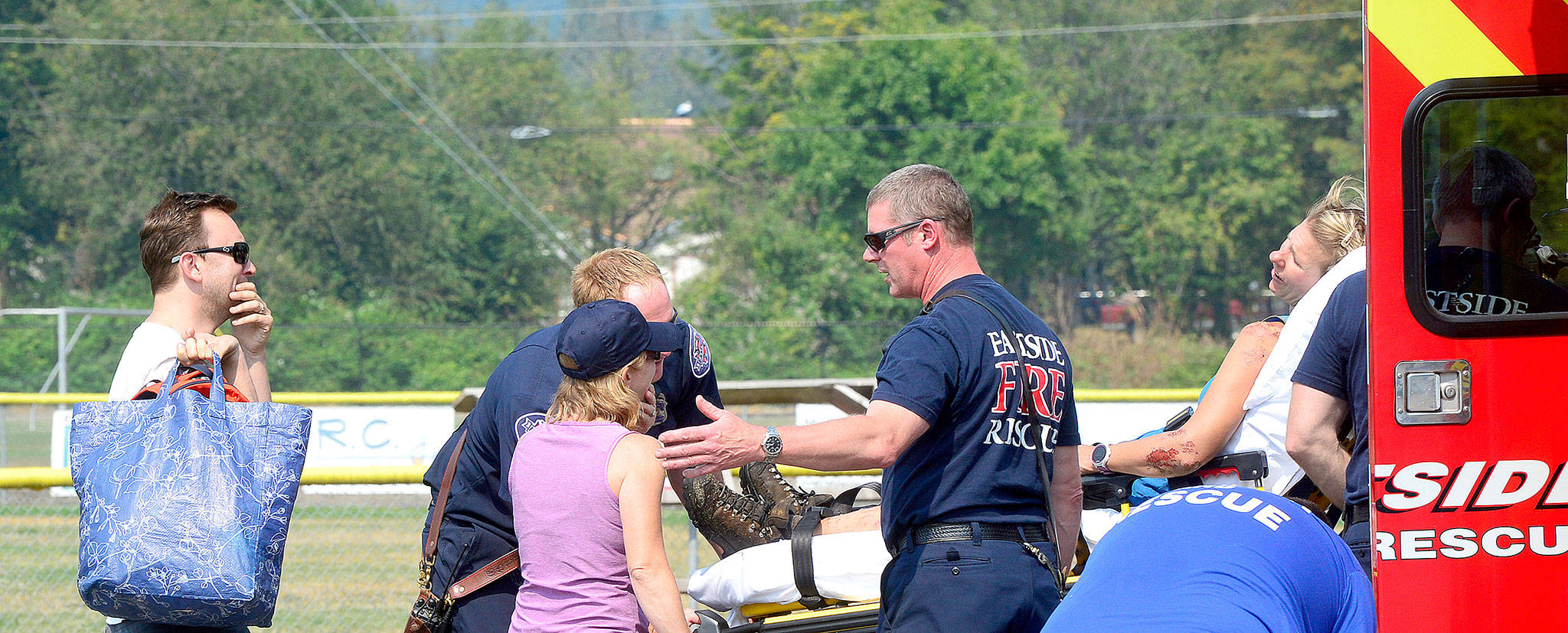 Haines&rsquo; husband, left, and sister gather around her stretcher.                                Photo courtesy of Mary Miller