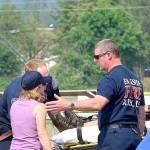 Haines&rsquo; husband, left, and sister gather around her stretcher.                                Photo courtesy of Mary Miller