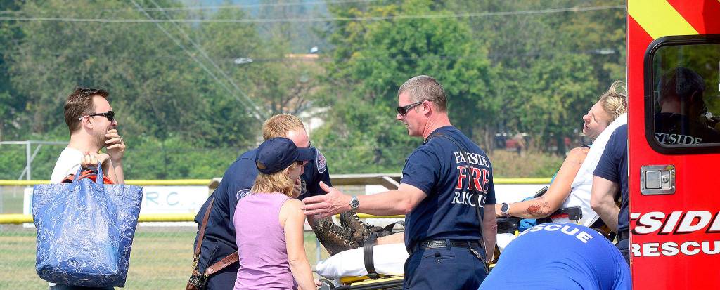 Haines&rsquo; husband, left, and sister gather around her stretcher.                                Photo courtesy of Mary Miller