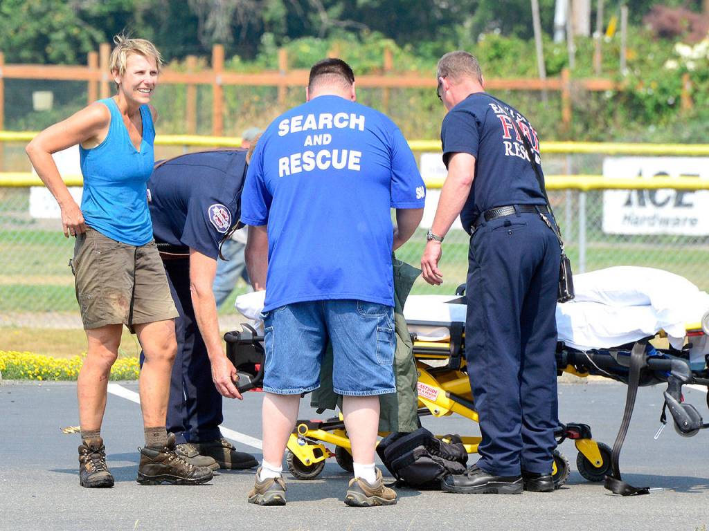 Haines, suffering from scrapes and a head injury, waits to be loaded into an ambulance.                                Photo courtesy of Mary Miller
