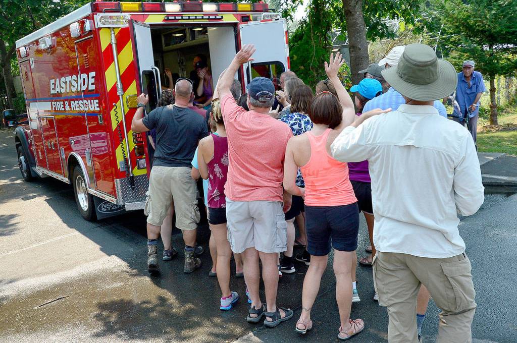 Family members wave as an ambulance prepares to transport Haines to an Issaquah hospital.                                Photo courtesy of Mary Miller