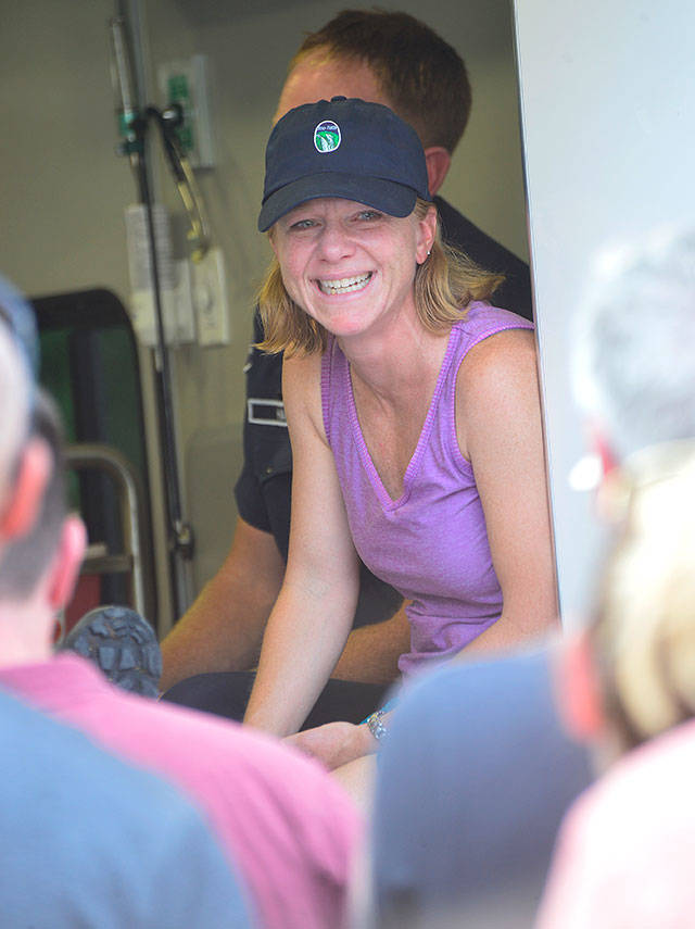 Haines&rsquo; sister flashes a joyous smile as she sits next to her in the ambulance.                                Photo courtesy of Mary Miller