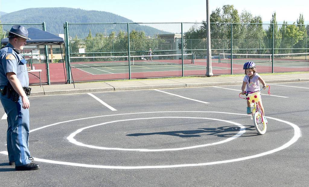 Molly Drango, 6, completes a figure-eight exercise at the Tanner Jeans Bike Rodeo Aug. 1.                                (Carol Ladwig/Staff Photo)