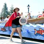 Snoqualmie Tribe members march with their float in the 2016 parade. File Photo