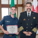 Snoqualmie Fire Chief Mark Correira, right, congratulates volunteer firefighter Tanner Webb on his graduation, with honors, from the state Fire Training Academy.                                (Courtesy Photo)
