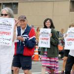 Snoqualmie Valley Indivisibles members march along North Bend way during the parade.                                (Evan Pappas/Staff Photo)