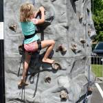Claire Schultz, age 7, starts a lightning-quick climb to the top of the rock wall at the Snoqualmie Valley YMCA&rsquo;s fifth anniversary party Sunday on Snoqualmie Ridge. (Carol Ladwig/Staff Photo)