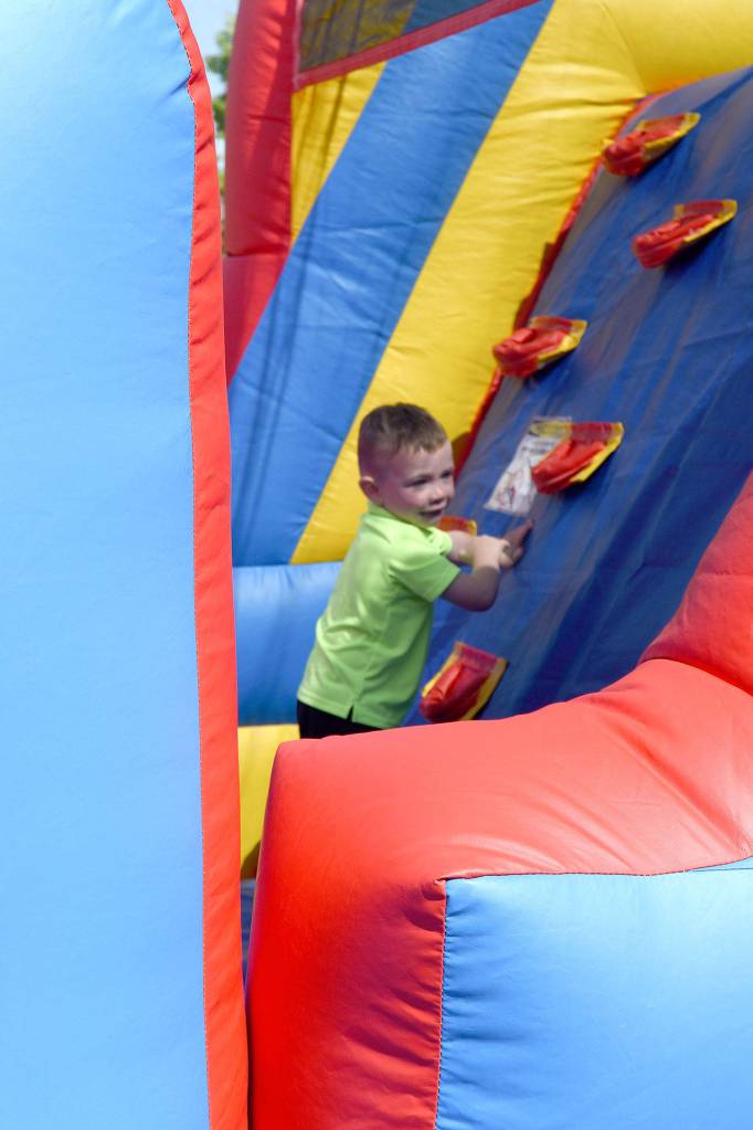 James Rooney climbs in a bounce house Sunday at the YMCA&rsquo;s community celebration. (Carol Ladwig/Staff Photo)