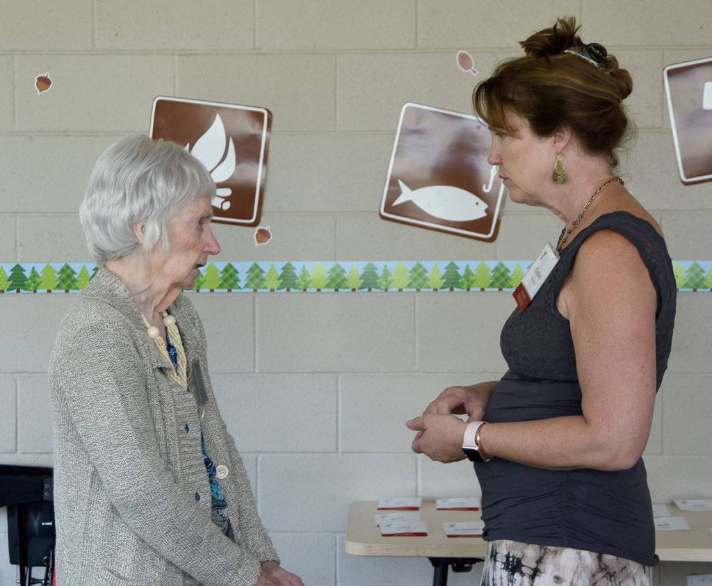 Gloria McNeely, a founding board member of the original Snoqualmie YMCA, chats with current board member Chelley Patterson at Sunday&rsquo;s event. (Carol Ladwig/Staff Photo)