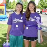 Volunteers Maddie and Gabi Parrish suit up for Sunday&rsquo;s celebration with balloon creations. (Carol Ladwig/Staff Photo)