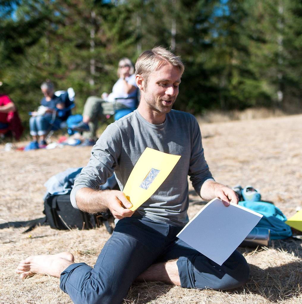 Using a pinhole projector a man reproduces the eclipse on a piece of paper for eclipse watchers at Snoqualmie Point Park.                                (Photo courtesy of Kristin Tetuan)