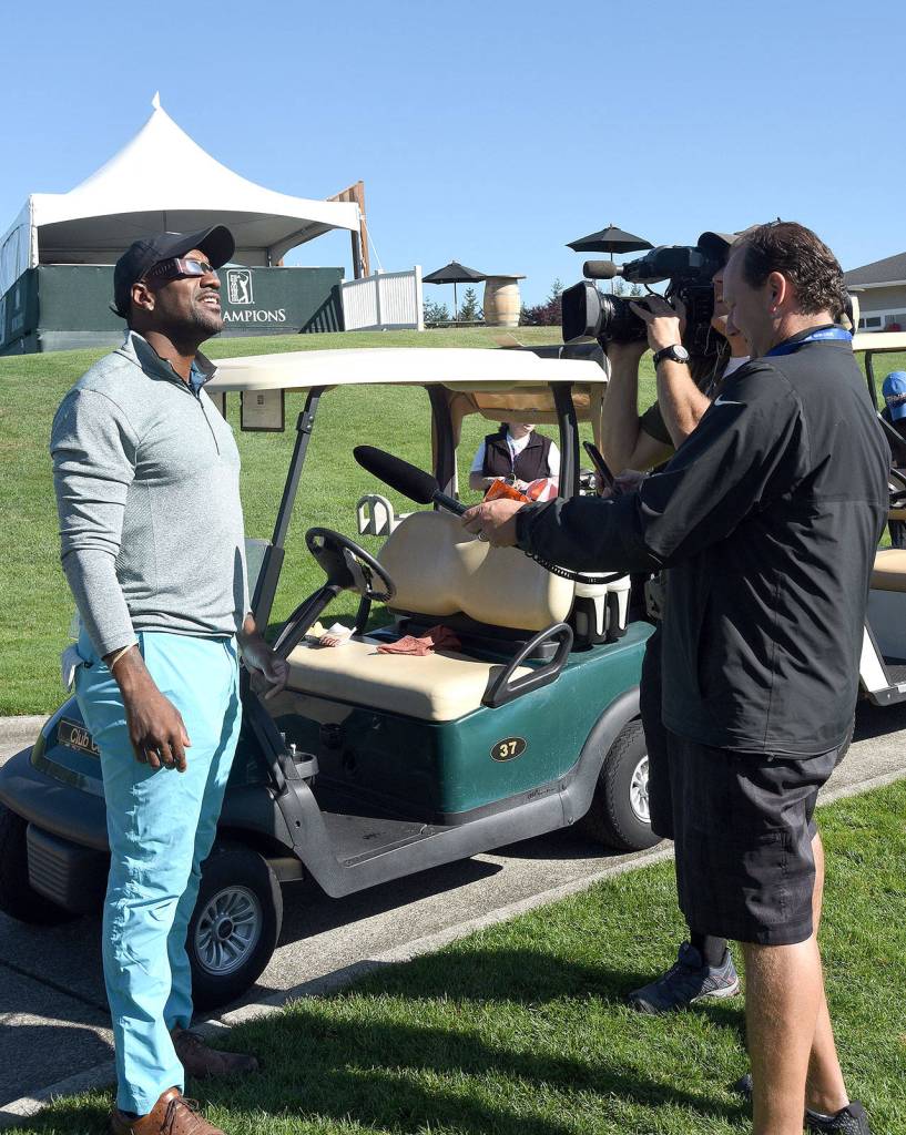 Seattle Seahawk alumnus Jordan Babineaux tries out his eclipse viewers between holes Monday at the Boeing Classic&rsquo;s Rumble at the Ridge tournament, a fundraiser for the Benaroya Research Institute at Virginia Mason and Seahawks Head Coach Pete Carroll&rsquo;s &lsquo;A Better Seattle&rsquo; initiative.                                (Carol Ladwig/Staff Photo)
