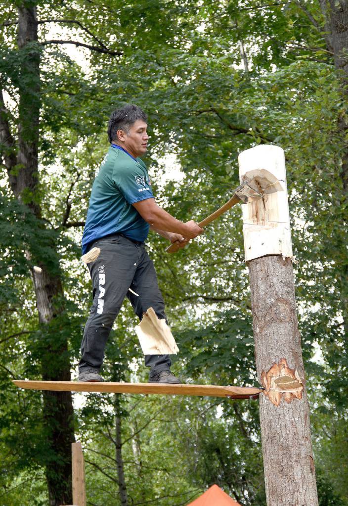 Chunks of wood fly as David Moses demonstrated the springboard event in Sunday&rsquo;s timber sports show.                                (Carol Ladwig/Staff Photo)