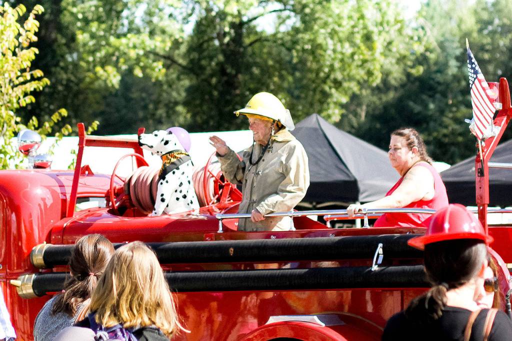 Grand Marshal Ed Wentz had the place of honor in Saturday&rsquo;s Railroad Days parade, in the Snoqualmie Fire Department&rsquo;s historic truck. Wentz was a longtime volunteer firefighter and former assistant chief of the department.                                (Jessie Koon Photo)