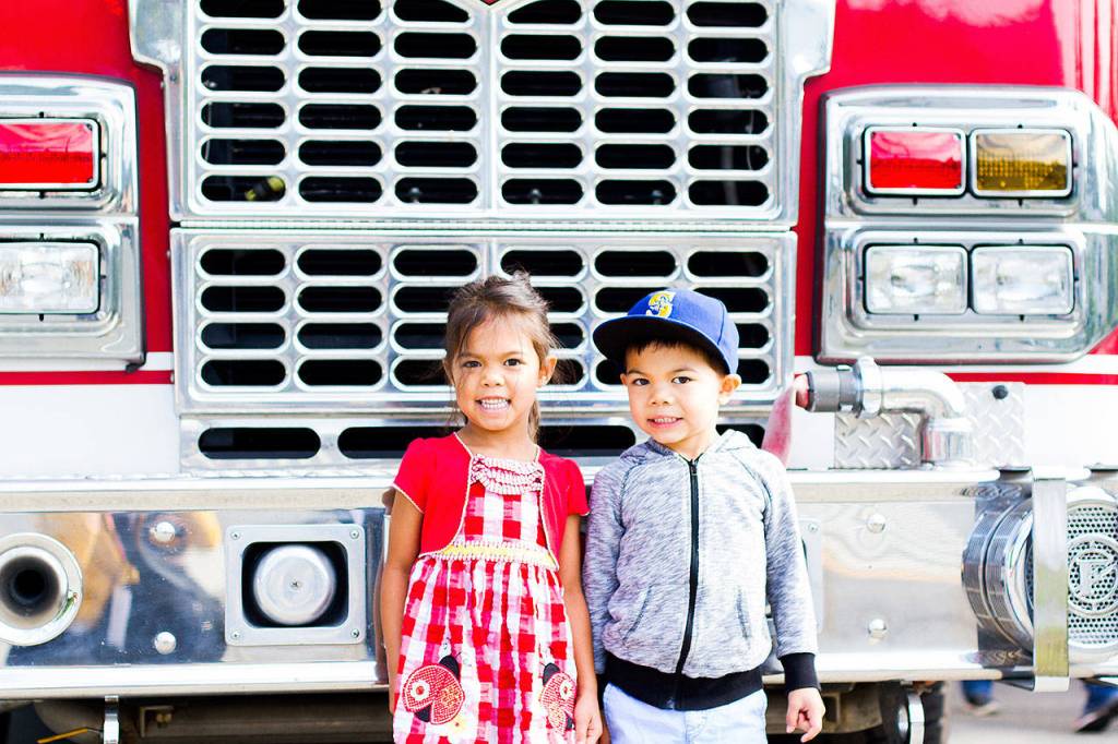 Twins Mila and Owen, 4 and a half years old, in front of a firetruck before the Snoqualmie Fire Department&rsquo;s annual pancake breakfast Saturday.                                (Jessie Koon Photo)