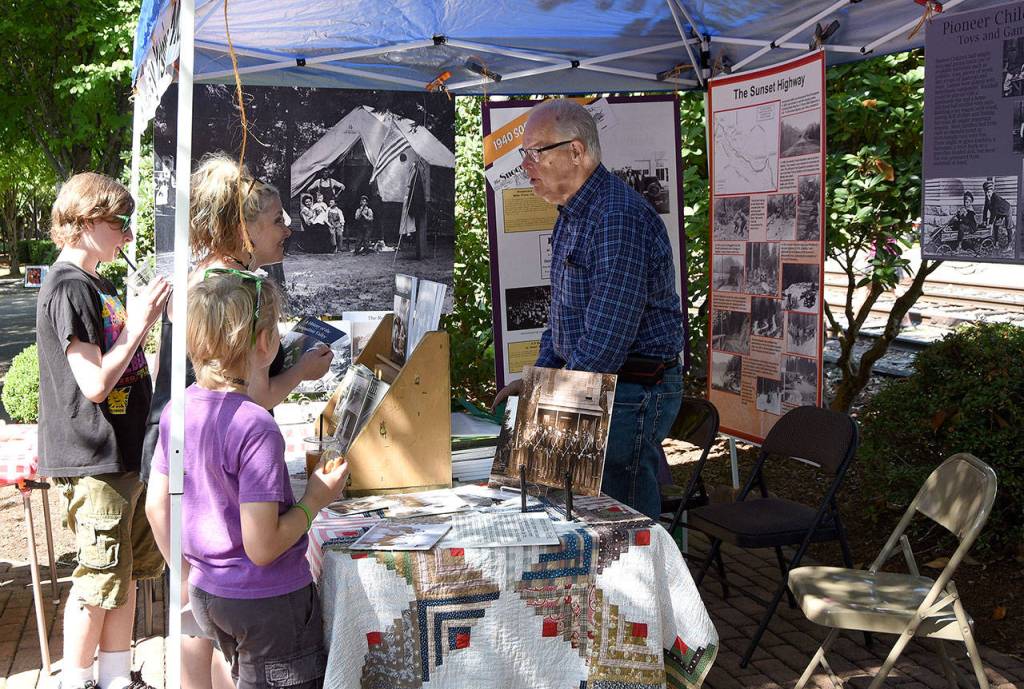 Snoqualmie Valley historian Dave Battey talks with visitors at the Snoqualmie Valley Historical Museum booth Saturday during Railroad Days.                                (Carol Ladwig/Staff Photo)