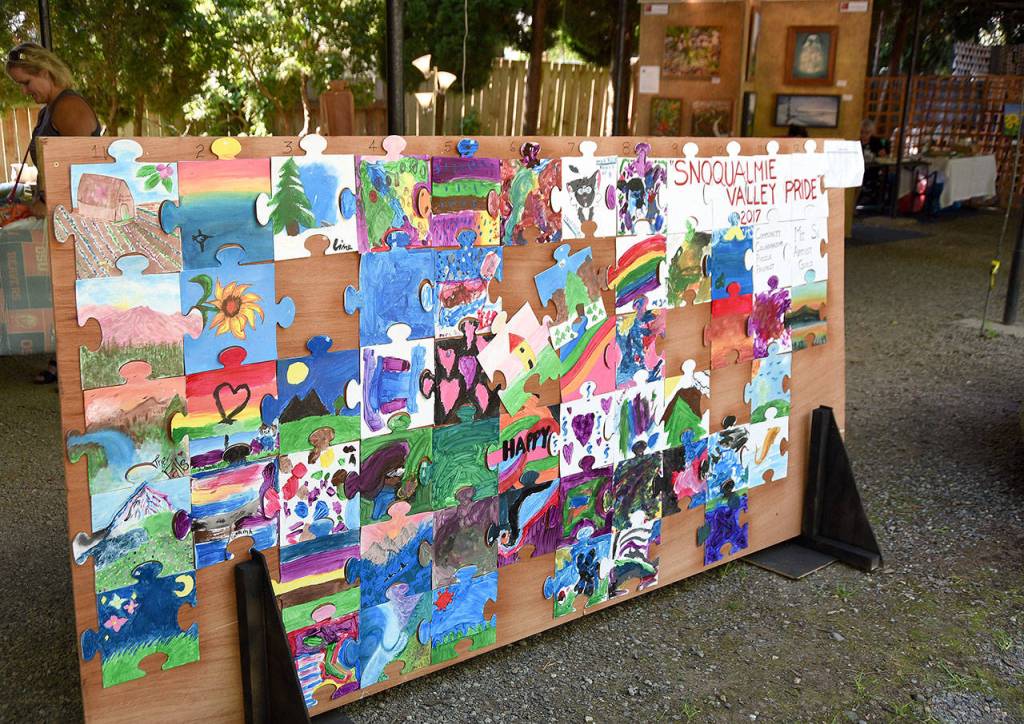A colorful mosaic of hand-painted puzzle pieces, created by children at North Bend&rsquo;s Block Party in July, was on display at Arts in the Park during Railroad Days. The project was sponsored by the Mount Si Artist Guild.                                (Carol Ladwig/Staff Photo)