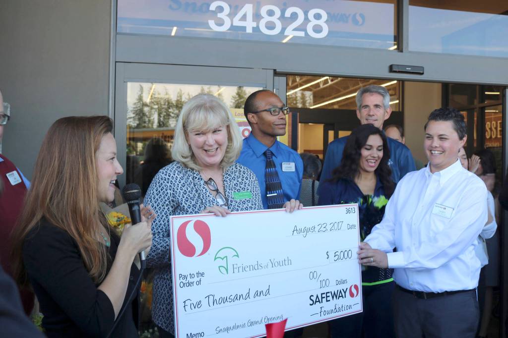 Terry Pottmeyer, CEO of Friends of Youth, receives a $5,000 donation from the Safeway Foundation at the grand opening event.                                (Evan Pappas/Staff Photo)
