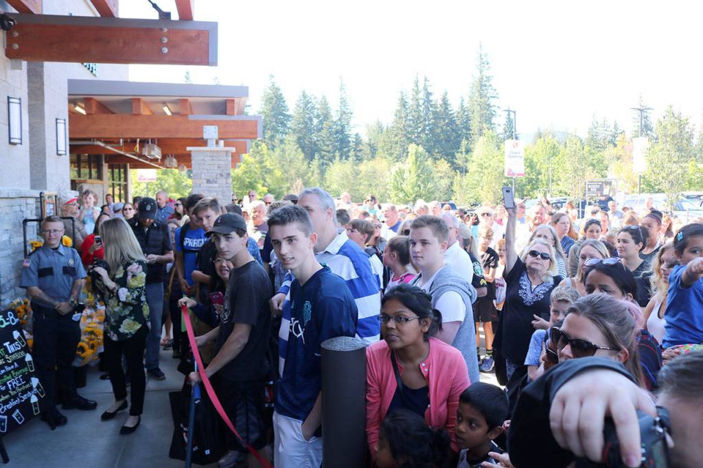 A large crowd gathers around the entrance to the store just before the doors are open for the first time.                                (Evan Pappas/Staff Photo)