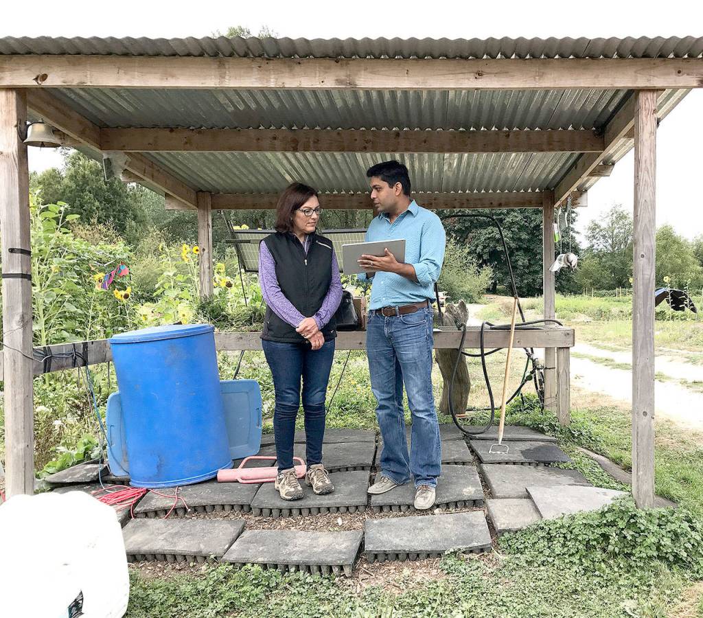 Microsoft researcher Ranveer Chandra, right, shows Congresswoman Suzan DelBene the types of data that can be tracked through the FarmBeats project, on a visit to Dancing Crow Farm in the Valey.                                (Courtesy Photo)