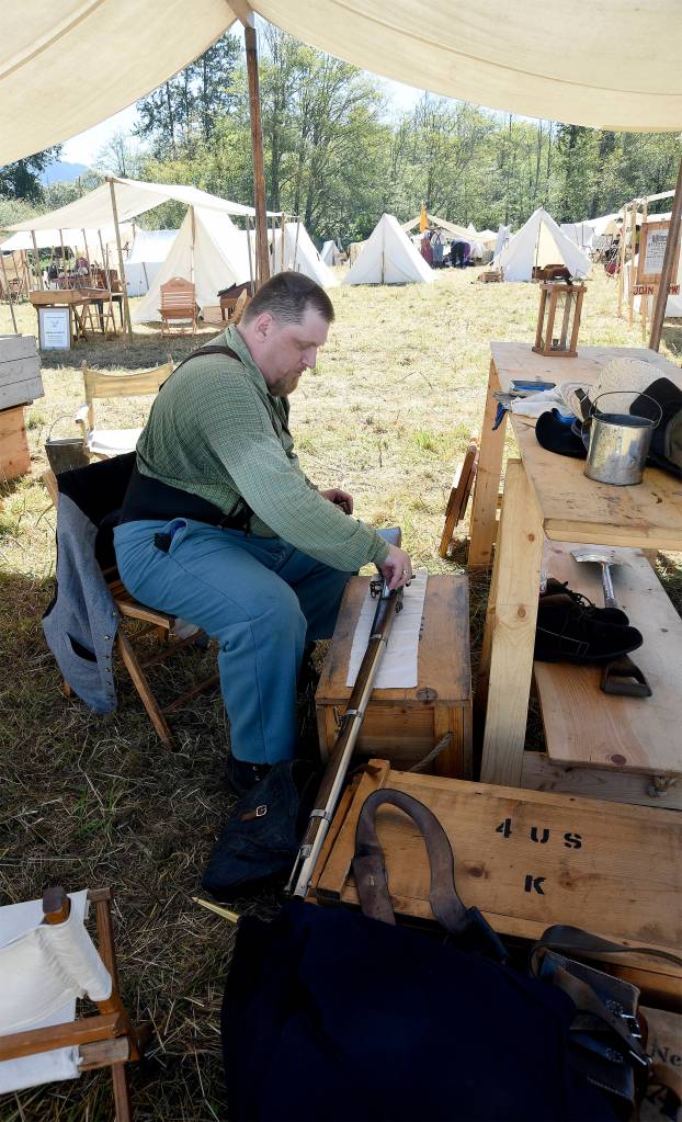 Carl Hicks of Lakewood, cleans his muzzle-loading musket Sunday morning in the Union camp of the 2016 Battle of Snoqualmie, a historical re-enactment at Meadowbrook Farm.
