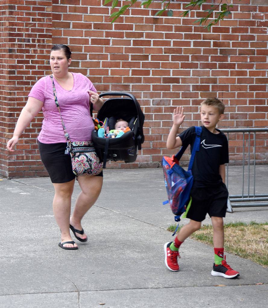 Brody LaBelle waves at friends as his mom, Melissa drops him off at school Wednesday. (Carol Ladwig/Staff Photo)
