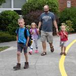 &ldquo;It&rsquo;s the most wonderful time of the year,&rdquo; says Mark Smith, after dropping off his son, Gibson, front, and daughter Camille, left, at their classrooms Wednesday. Bryson, right, starts preschool soon. (Carol Ladwig/Staff Photo)