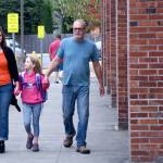 Kate Swanson, center, holds hands with her parents, Ann and Eric as she walks into Fall City Elementary School Wednesday. (Carol Ladwig/Staff Photo)